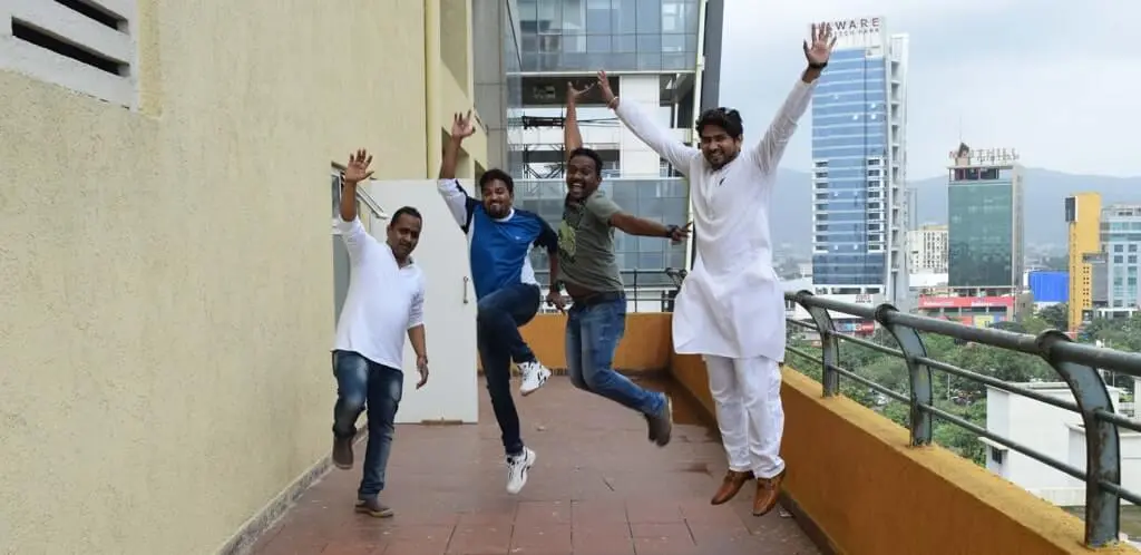 A group of Focalworks employees joyfully leaping in the air with raised arms.