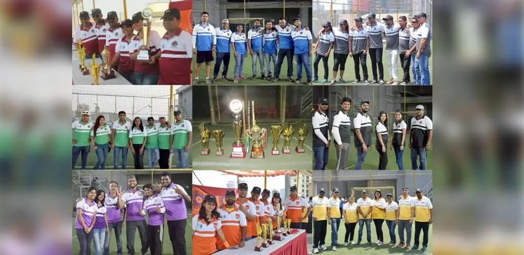 Focalworks Team Engaging in a Cricket Match Outdoors, With Awards and Trophies in the Background.