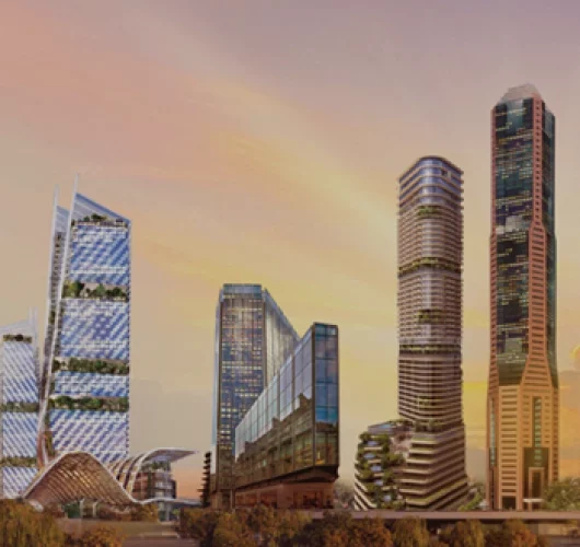 Futuristic cityscape at sunset featuring tall, glass skyscrapers with lush greenery integrated into their designs, surrounded by orange-lit sky.